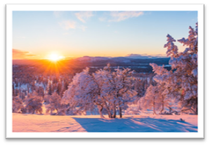 Image of sun on horizon in snowy landscape in winter
