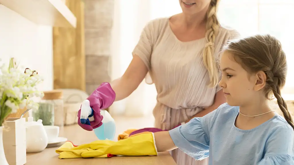 Photo of Mother and Daughter cleaning desk