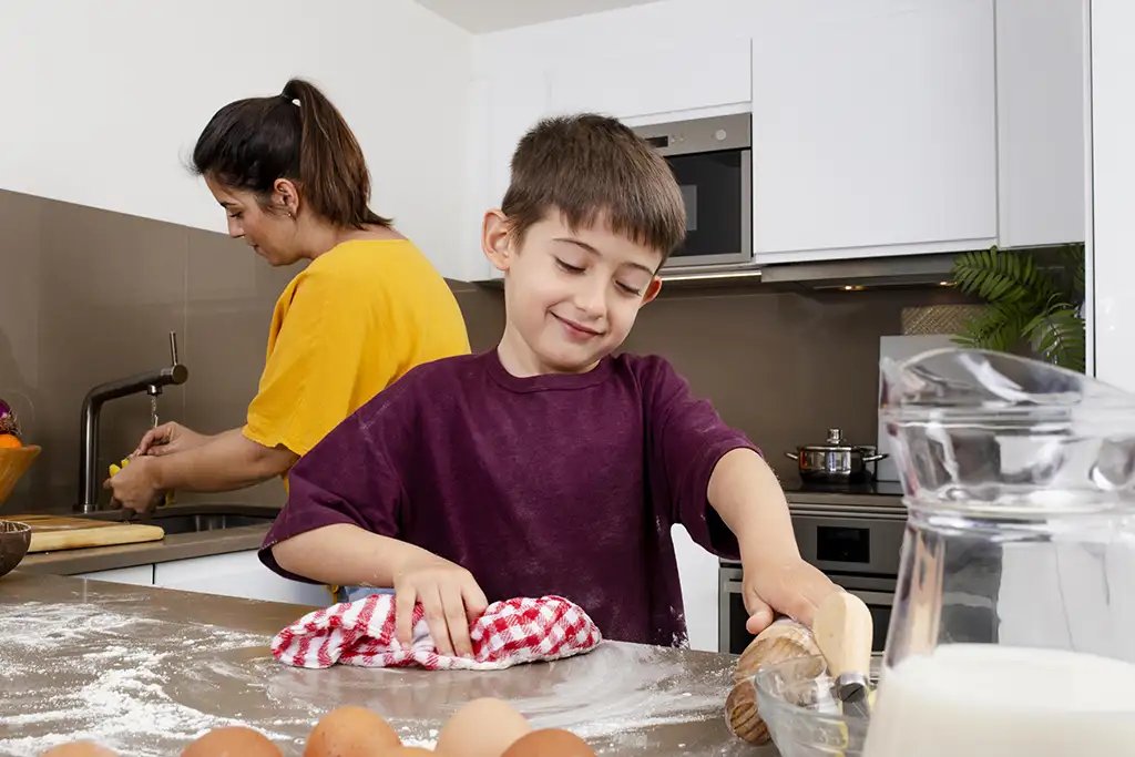 Photo of mother and son cleaning kitchen